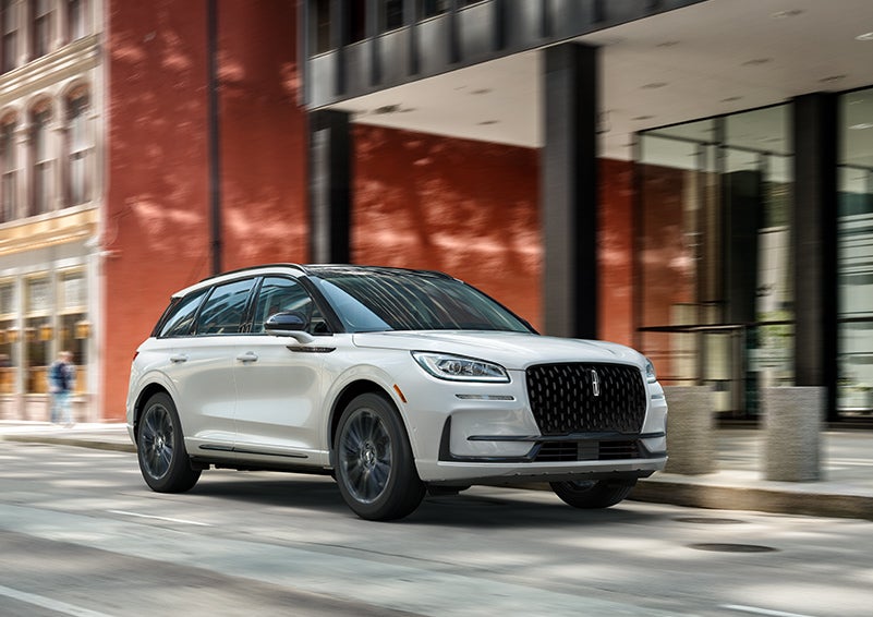 The 2024 Lincoln Corsair® SUV with the Jet Appearance Package and a Pristine White exterior is parked on a city street. | Gary Yeomans Lincoln Ocala in Ocala FL
